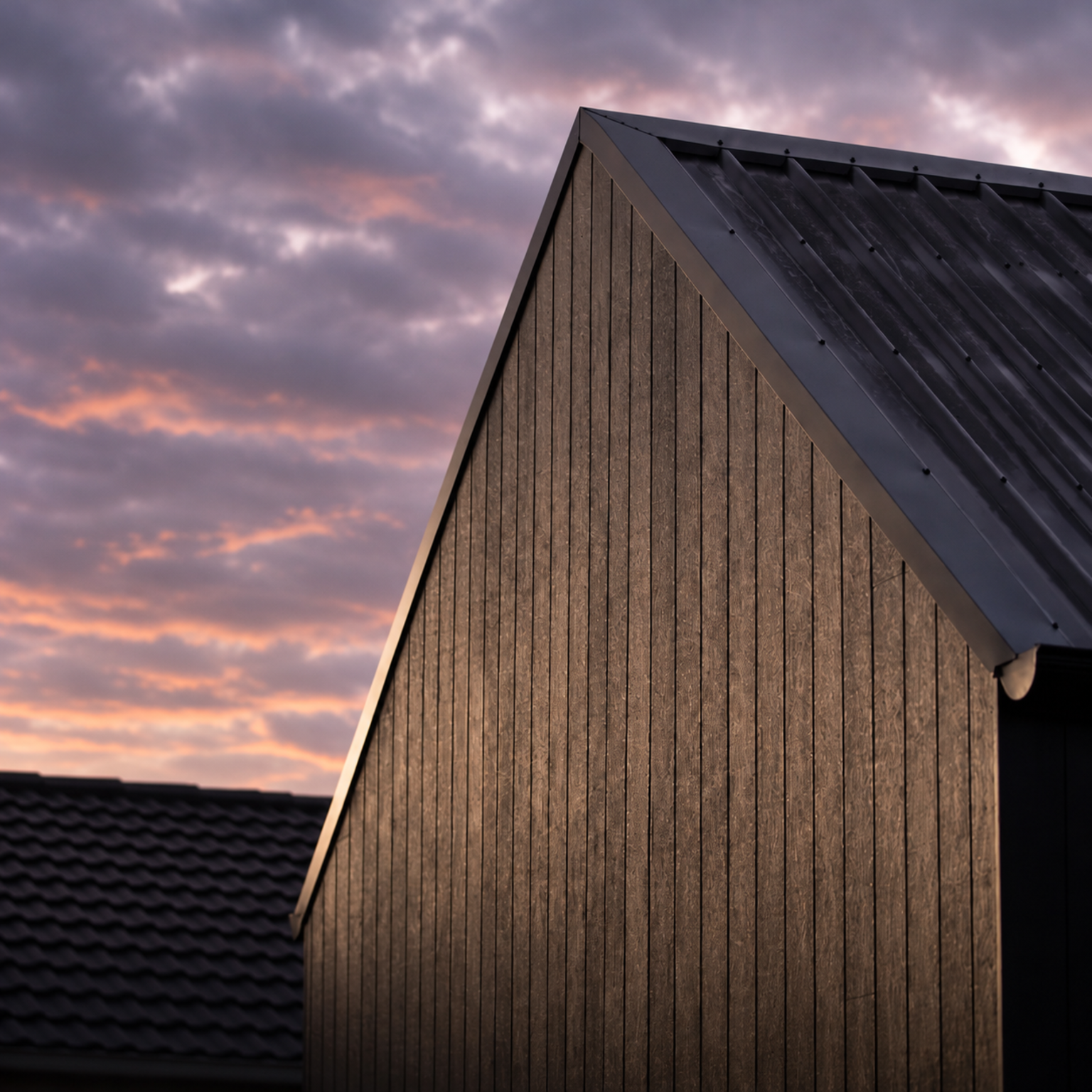 Illustrative timber gable and dark metal roof against a dusk sky